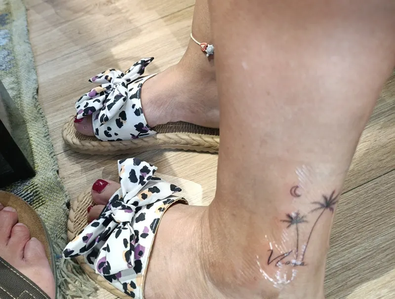 Small fine line palm trees and moon on an ankle