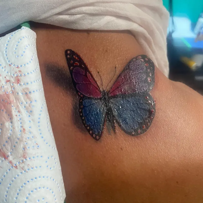 Realistic blue and purple butterfly, freshly tattooed